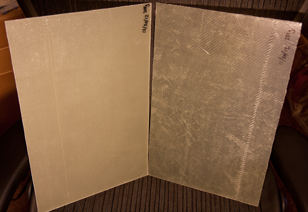 The new layup on the left looks a lot better than the old one on the right. There are many fewer white, dry spots. The weight is 10.9 oz, close to the ideal 11oz, but there's clearly still air in this one too. (The new one looks more opaque because I used peel ply on the back side, so the textured surface makes it less transparent.)