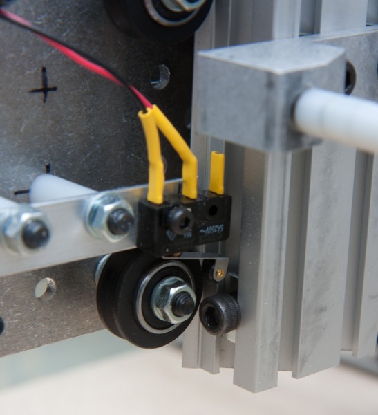 The Z-axis limit switch was more tricky, because there's nothing convenient to mount it on. Luckily, the spare nylon spacers from the Shapeoko kit had exactly the right length to trigger off a bolt screwed into the makerslide.