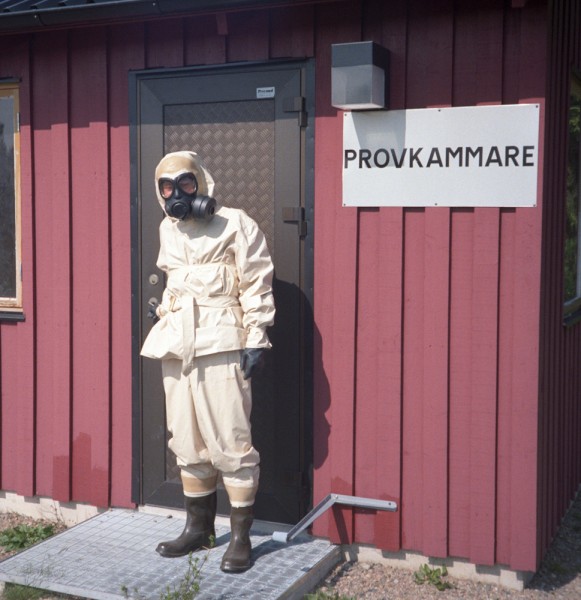 An old picture from my military service, showing the chemical protection suits and gas masks we used. "Provkammare" means "testing chamber", where tear gas is used to make sure there are no leaks.