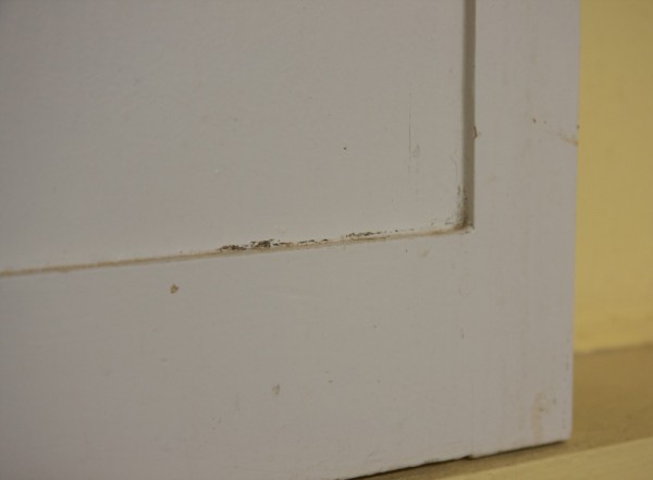 A closeup of the questionable condition of the paint on the cabinets. 