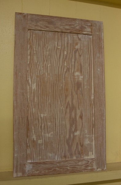 Here's a cabinet after stripping. I'm not sure what the wood is, but it has quite a noticeable grain pattern.
